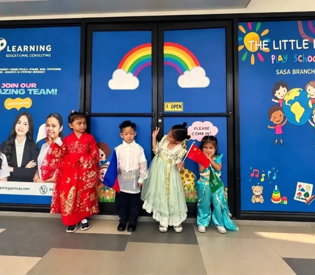 Preschoolers in United Nations Day costumes posing outside the playschool's rainbow-decorated entrance in Sasa, Davao City